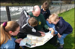 Ranger and children map-reading